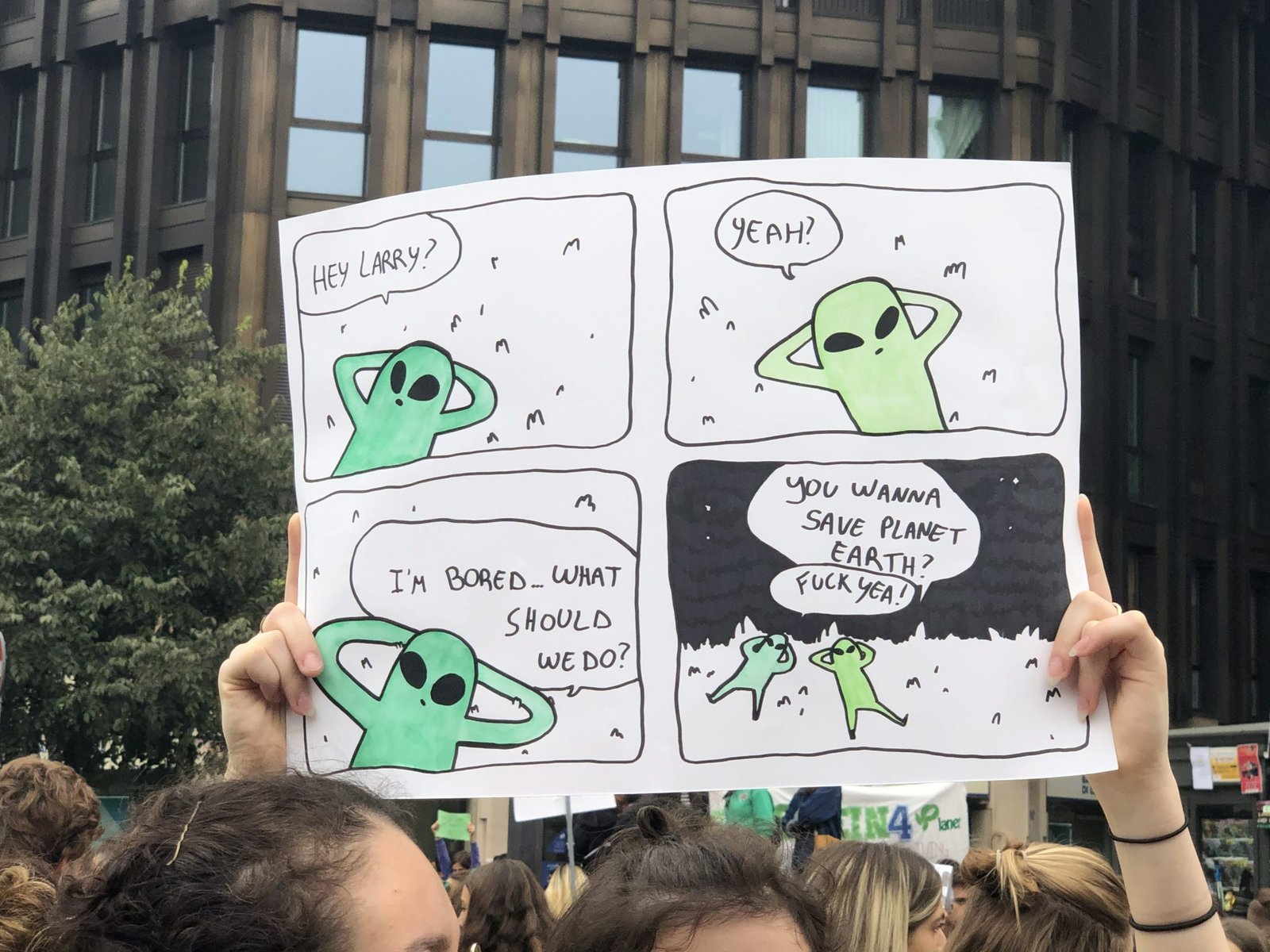 Cartello con una vignetta sugli alieni e il pianeta Terra